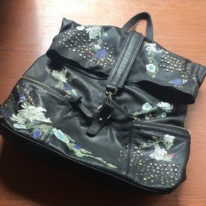 Black leather backpack with painted floral design